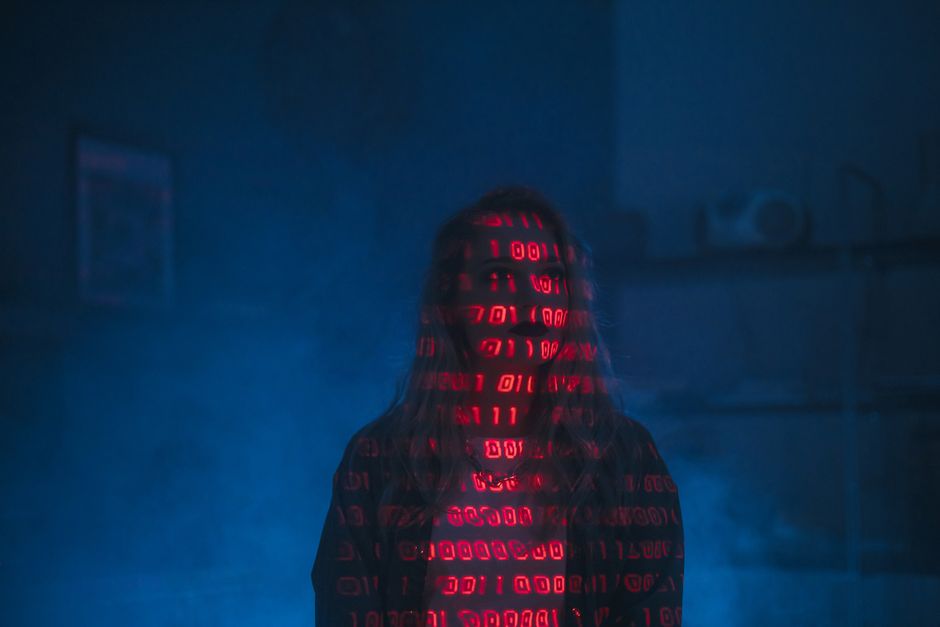 A close-up of a computer screen displaying HTML code with various tags and attributes in different colors, including headings, links, and div elements. The code appears to be part of a website's sourc